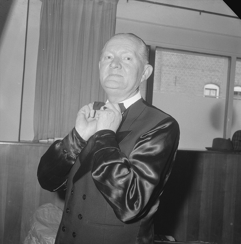 男士调整领结的特写，展现精致细节